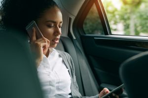 stress woman with technology in car